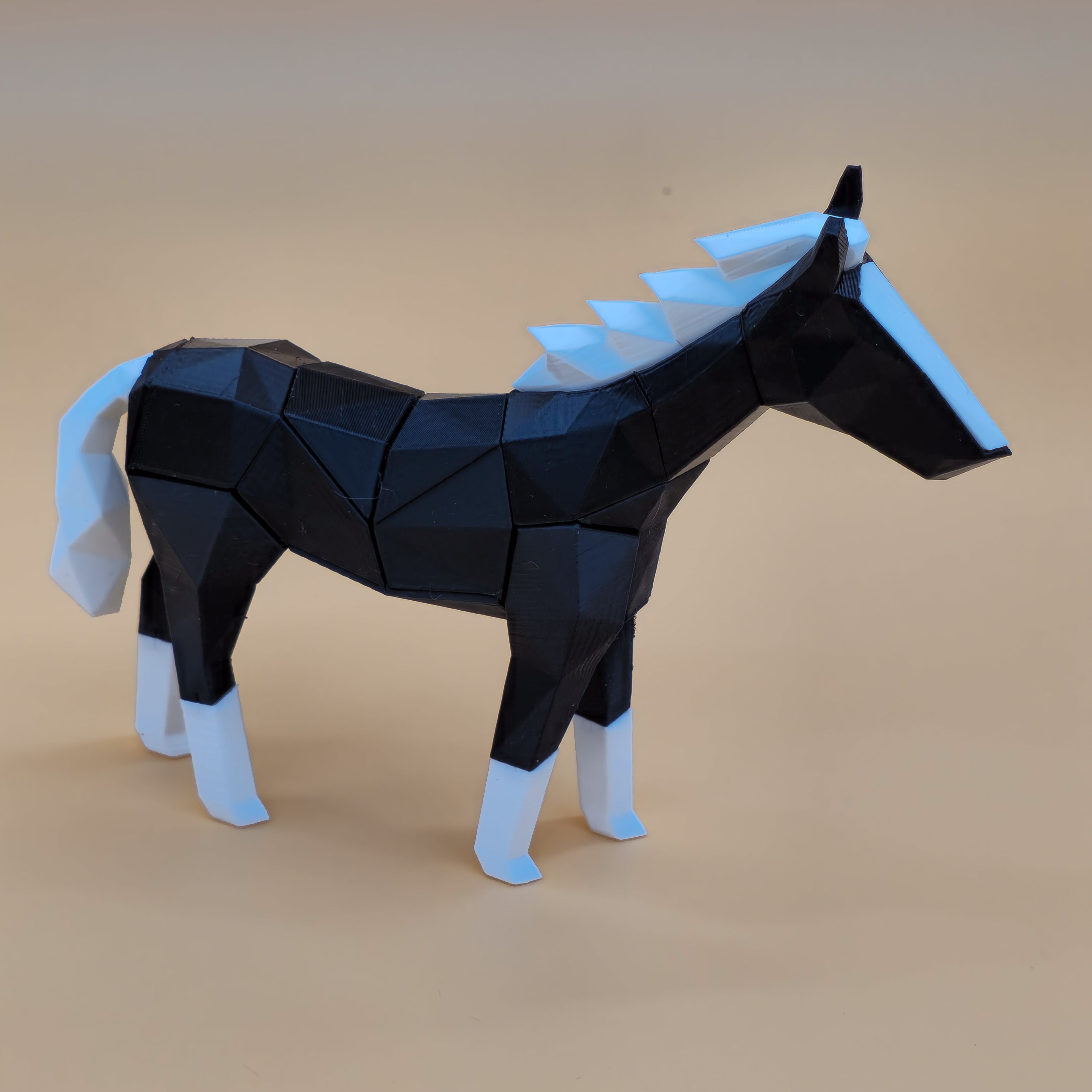 Black and white magnetic horse puzzle on a beige background
