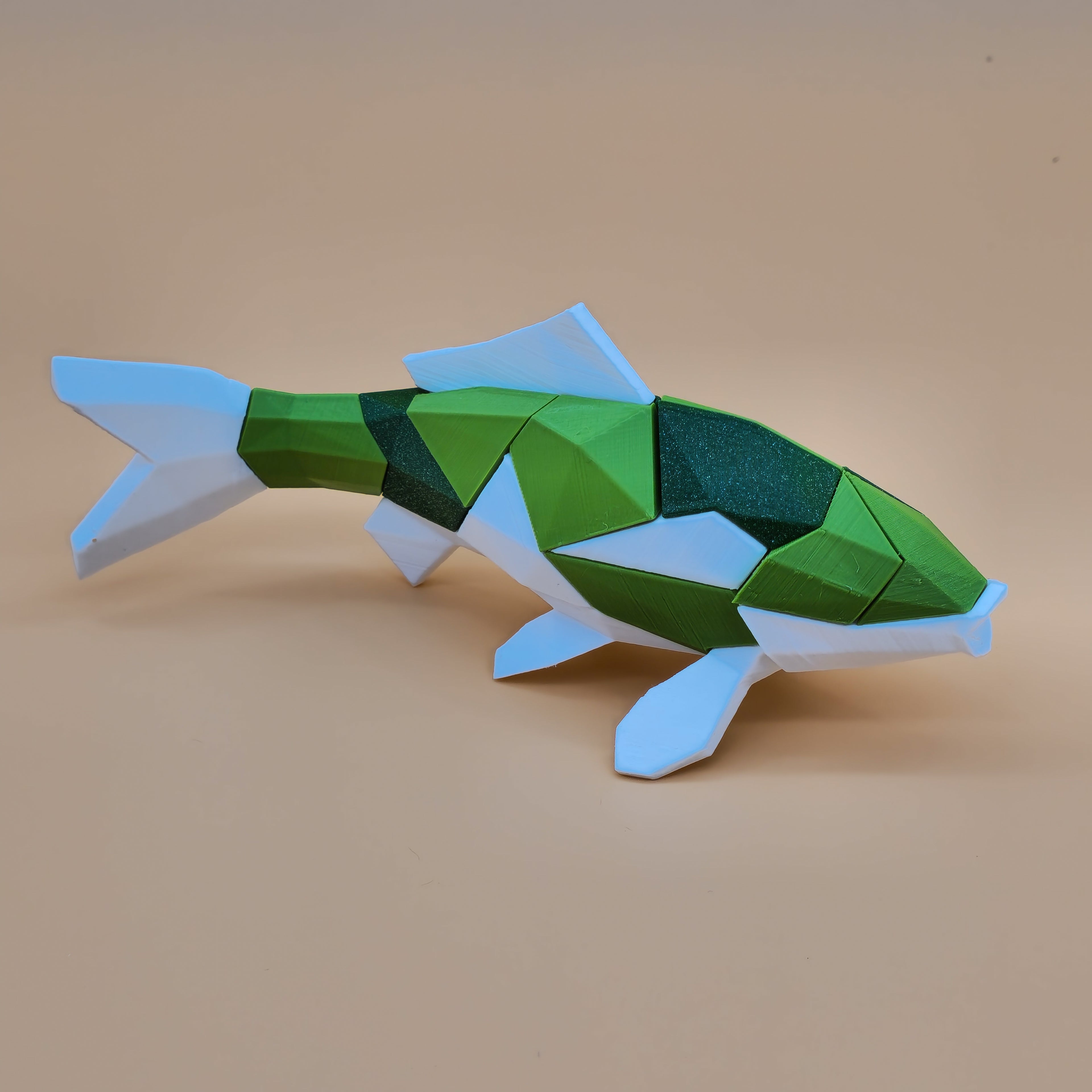 White, apple green, and glitter green 3D printed magnetic koi puzzle on a beige background