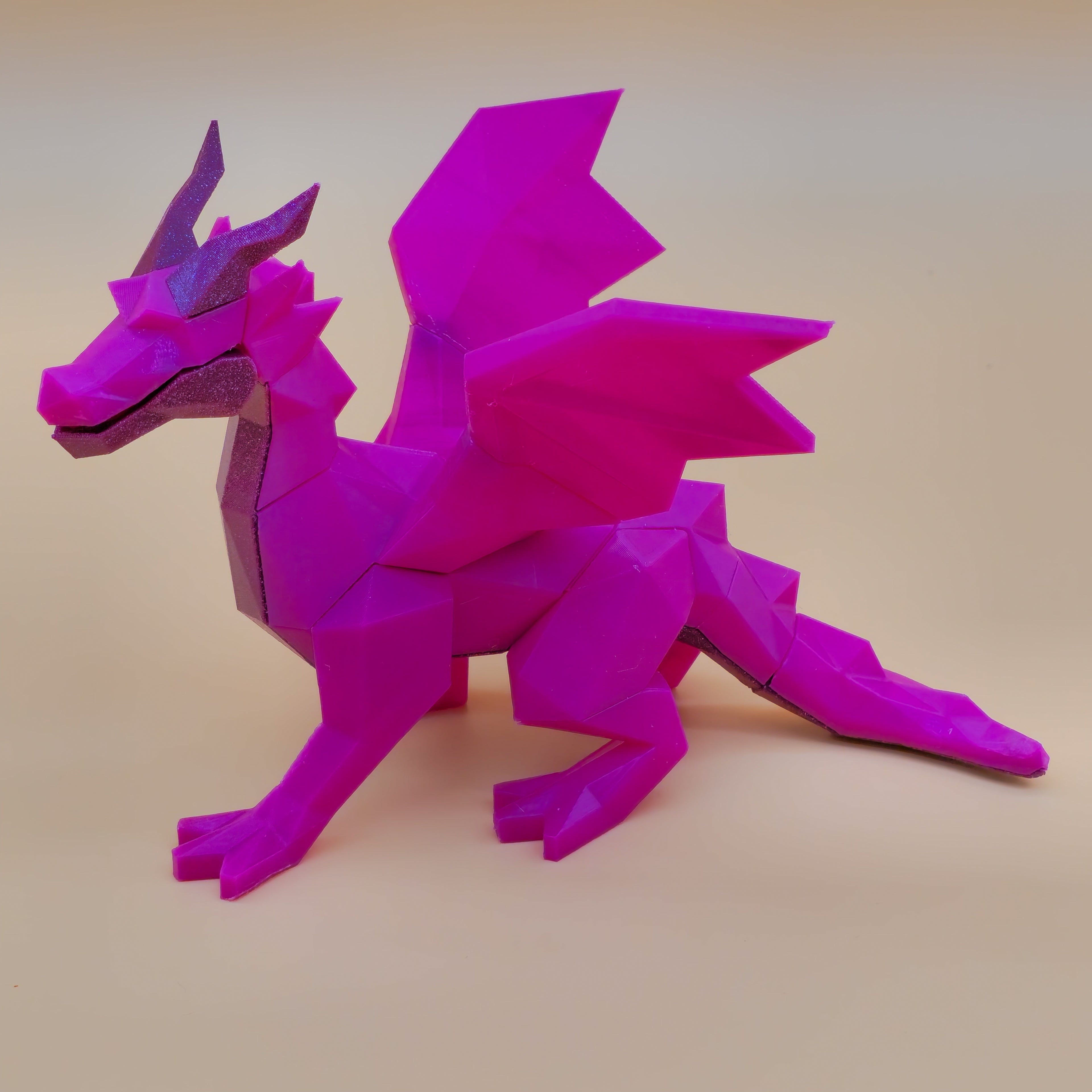Hot purple and glitter purple 4-legged winged dragon on a beige background